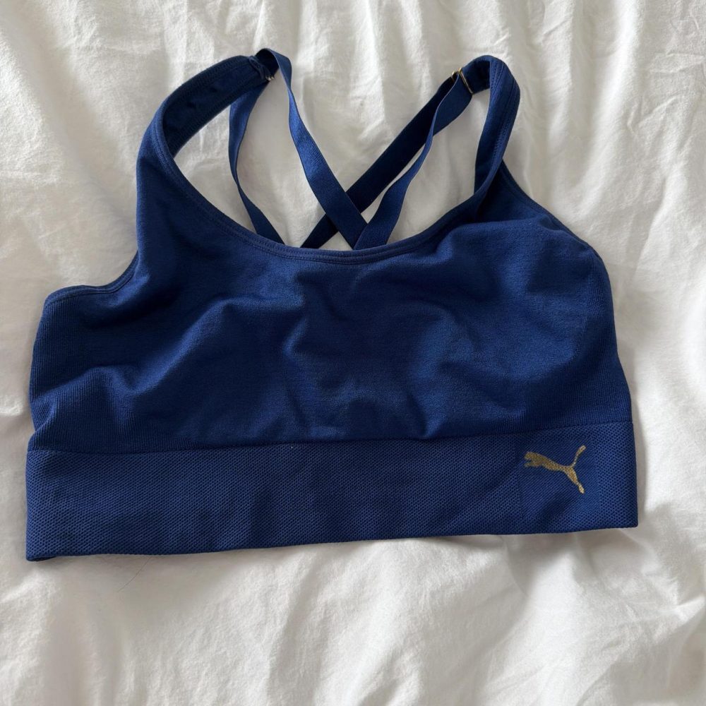 Puma blue sports bra with gold logo tags we’re cut out unsure on sizing probably